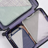 Open suitcase neatly packed with sustainable packing cubes in muted tones, ideal for eco-friendly corporate travel gifts