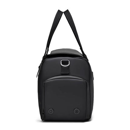 side view of caveri marlowe overnight duffle bag with a handles on a white background