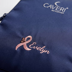 Caveri personalised packing cube in Ink Blue with embroidered pink ribbon butterfly