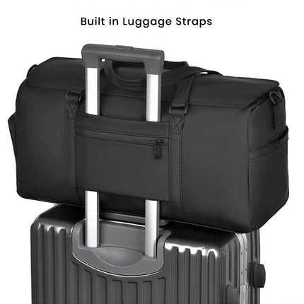 caveri marlowe Black duffel bag with built-in luggage straps on top of a suitcase.