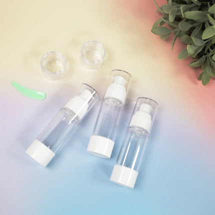 Caveri 6 piece travel bottle set with clear pump bottles and small cream jars laid flat on pastel background