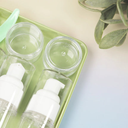 Caveri 6-piece travel bottle set with pump bottles and clear jars in sage green tray