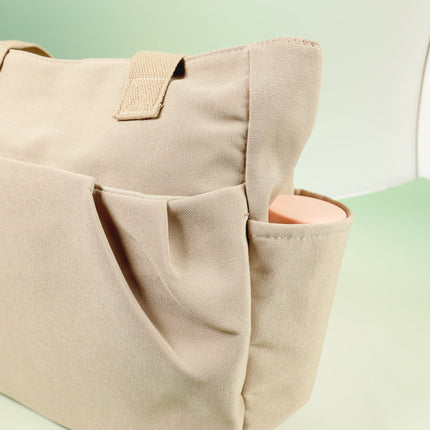 Caveri Beatrice bag in sand with exterior multi-pocket organiser and side bottle holder detail