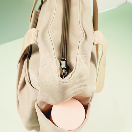 Caveri Beatrice bag in sand with top zip opening and side water bottle pocket