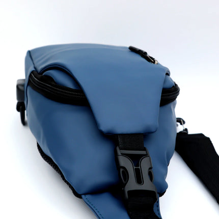 Caveri day bag in slate blue showing buckle clasp, zip detail and adjustable shoulder strap