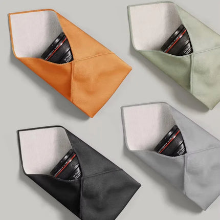 Caveri grip wrap in four colours — orange, sage, charcoal and grey — each wrapping a camera lens
