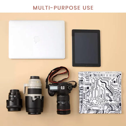 Caveri grip wrap circuit board print shown with laptop, tablet, DSLR camera and lenses for multi-purpose use