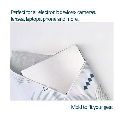 Caveri grip wrap cradling a laptop, shaped to fit electronics like cameras, lenses and phones
