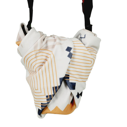 Caveri grip wrap in white with gold geometric print, bundled around luggage straps