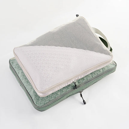 Caveri large compression packing cube in sage green open showing mesh lid and geometric print lining