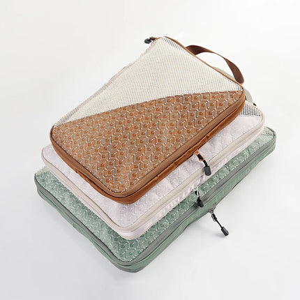 Caveri large packing cubes stacked in tan, white and sage green with geometric print and mesh panel