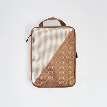 Caveri medium packing cube in tan with mesh panel and arrow print detail, front view