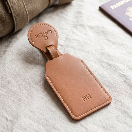 Caveri monogrammed luggage tag in Brown with debossed initials