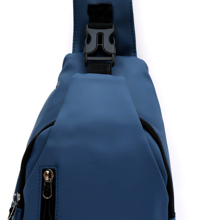 Caveri sling day bag in steel blue with adjustable chest strap buckle and front zip pockets