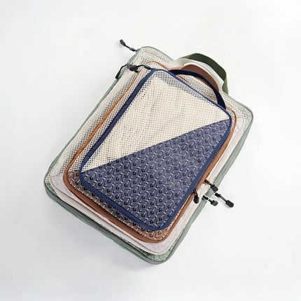 Caveri small packing cubes set stacked in sage green, navy and tan with mesh panel top view