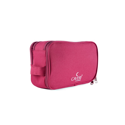 Caveri toiletry bag in raspberry pink with zip closure and carry handle, side angle view