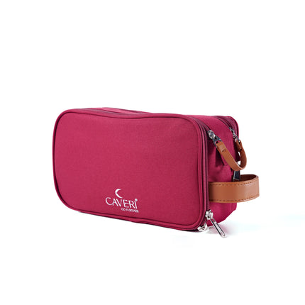 Caveri travel toiletry bag in raspberry with tan leather handle and dual zip compartments