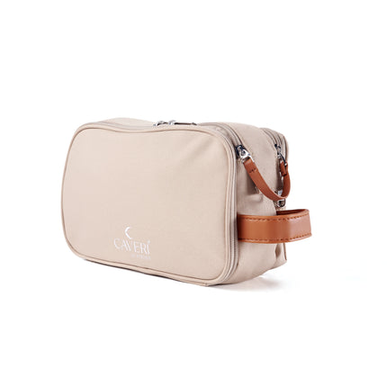 Caveri toiletry bag in sand beige with tan leather handle and silver zip, side angle view