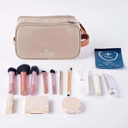 Caveri toiletry bag in sand beige with tan leather handle, shown with makeup brushes and skincare essentials