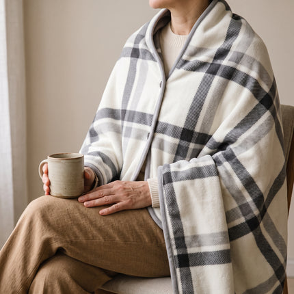 Caveri travel blanket wrap buttoned at the shoulders