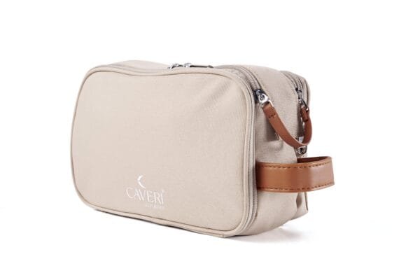 Neutral-toned sand toiletry bag by Caveri, featuring minimalist aesthetic and spacious compartment