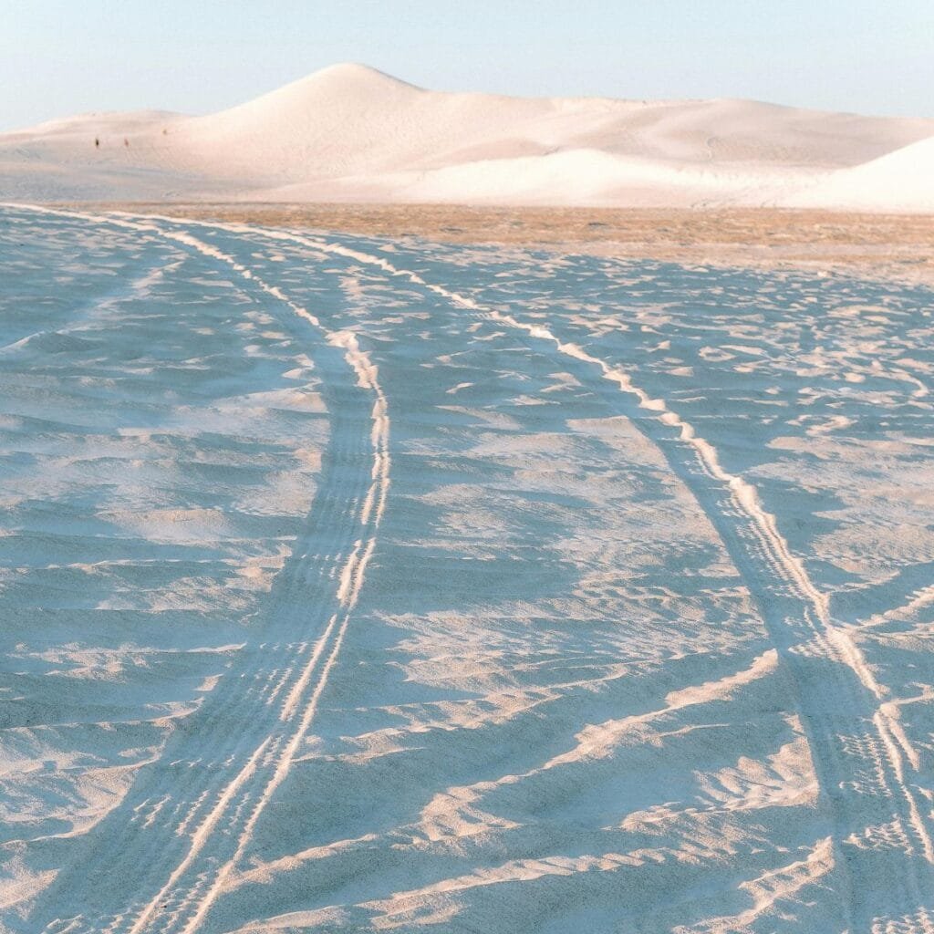 A stunning sunset over the Lancelin Dunes, with warm orange and pink hues lighting up the sky